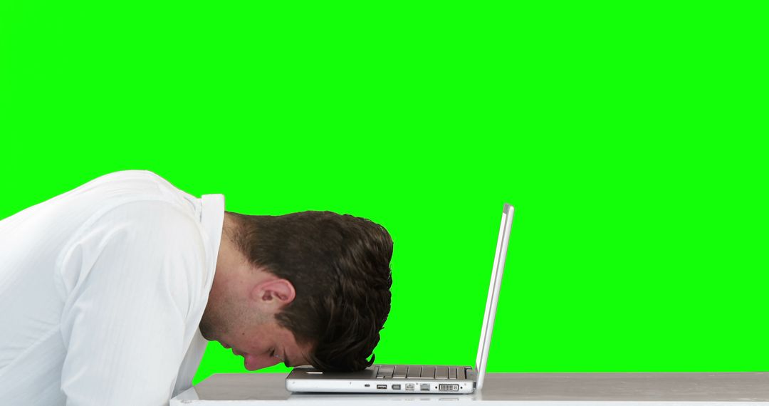 Stressed Man Head on Laptop Overwhelmed with Greener Background - Free Images, Stock Photos and Pictures on Pikwizard.com