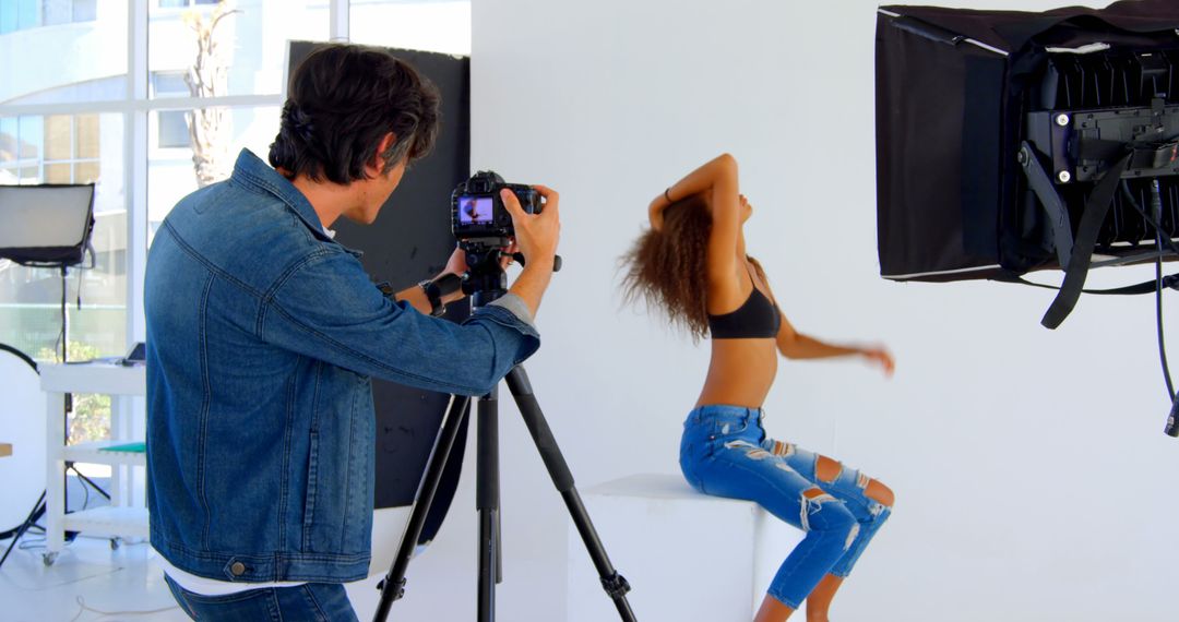 Photographer Shooting Female Model in Studio - Free Images, Stock Photos and Pictures on Pikwizard.com