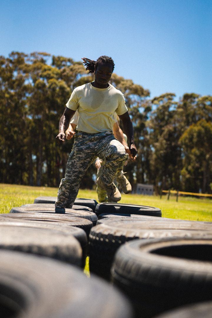 African American Soldier Running Through Tires During Bootcamp Training - Free Images, Stock Photos and Pictures on Pikwizard.com