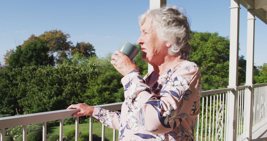 Senior Woman Enjoying Morning Coffee on Balcony in Sunny Weather - Free Images, Stock Photos and Pictures on Pikwizard.com