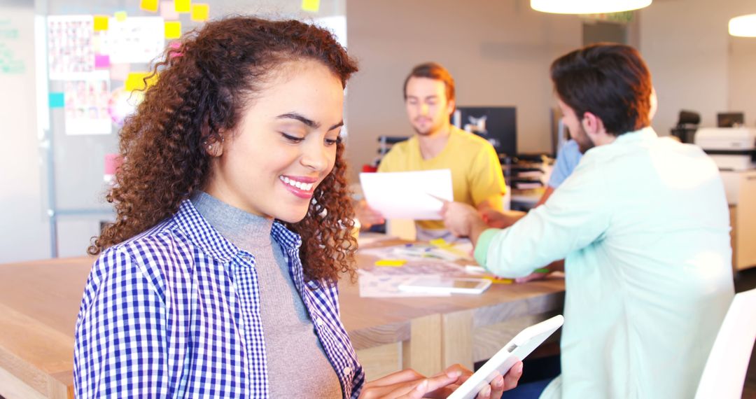 Young Woman Using Tablet in Collaborative Office Environment