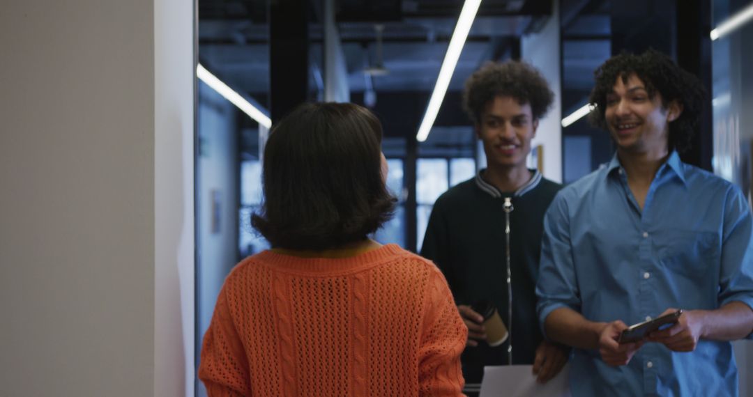 Colleagues Collaborating and Socializing in Modern Office Corridor