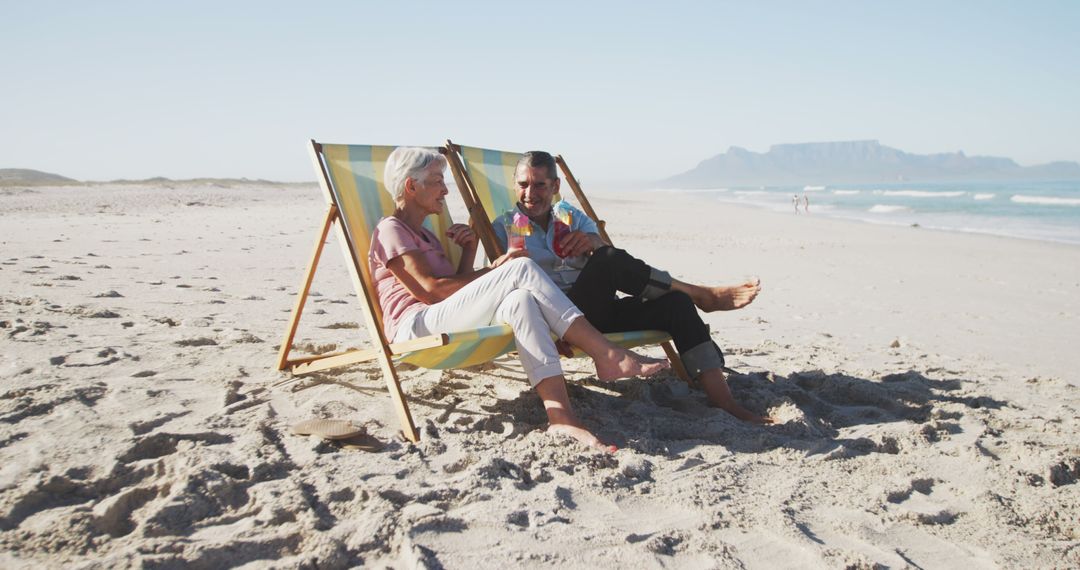 Senior Couple Relaxing in Deck Chairs on Beach - Free Images, Stock Photos and Pictures on Pikwizard.com