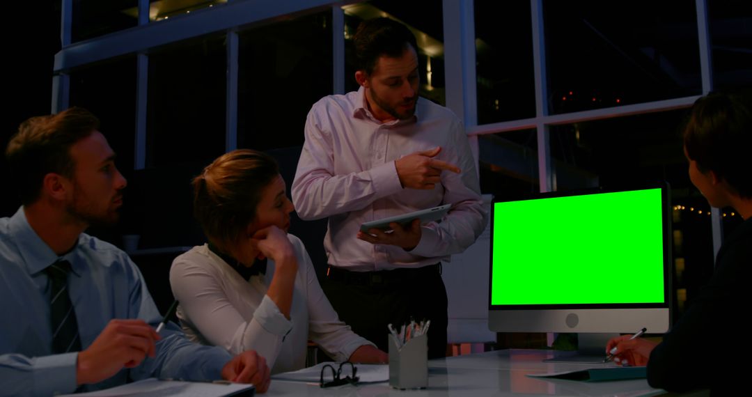 Business Team Analyzing Data on Computer With Green Screen in Office at Night - Free Images, Stock Photos and Pictures on Pikwizard.com