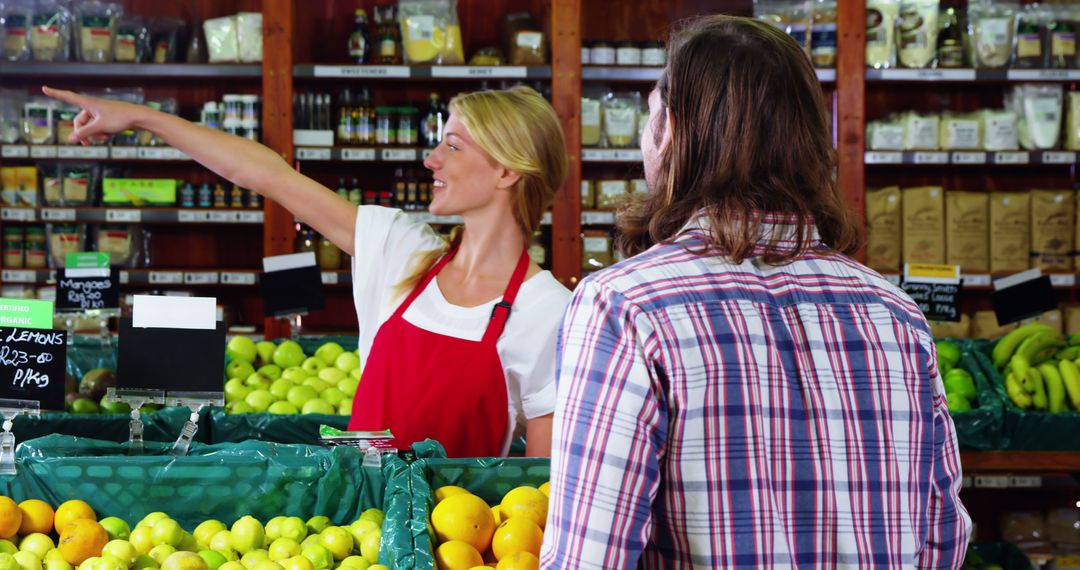 Female grocery store clerk assisting customer with direction - Free Images, Stock Photos and Pictures on Pikwizard.com