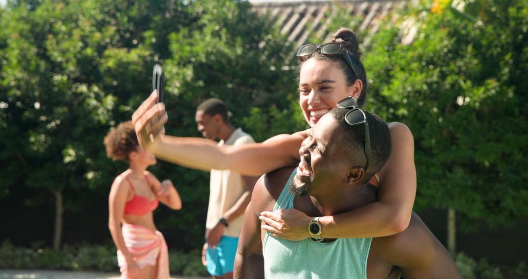 Diverse Friends Taking Piggyback Selfie in Sunny Garden