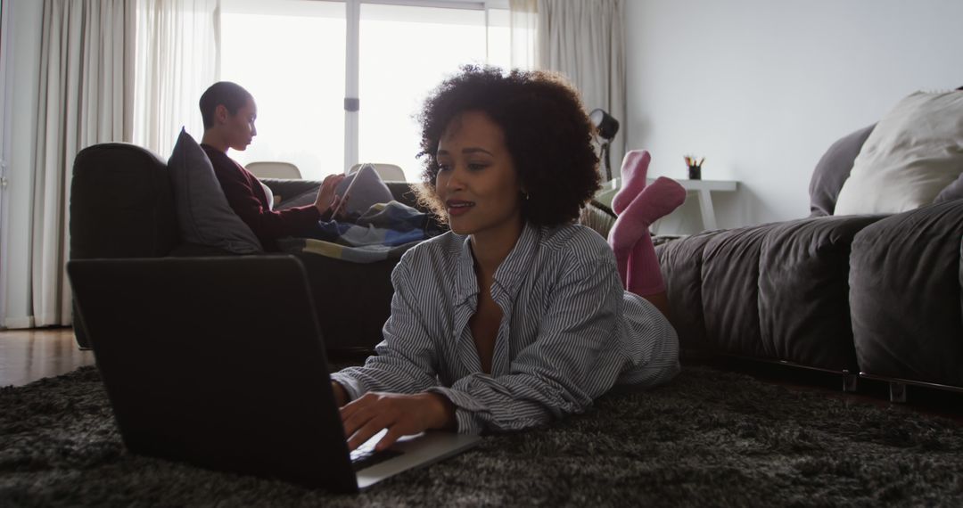 Lesbian Couple Relaxing with Technology at Home