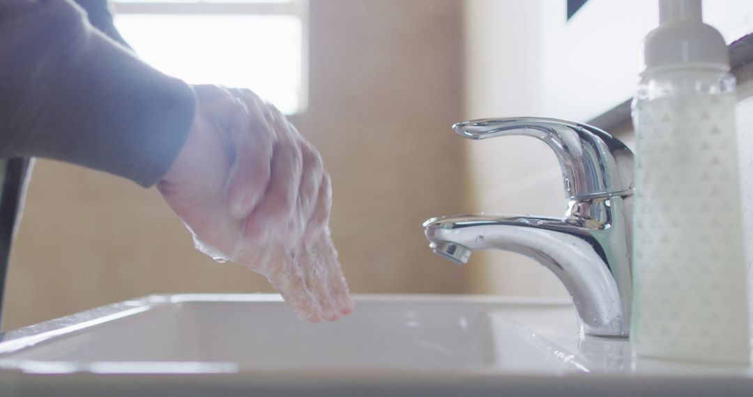 Washing Hands with Soap Above Bathroom Sink - Free Images, Stock Photos and Pictures on Pikwizard.com