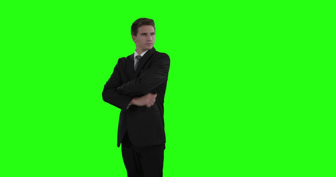 Businessman In Suit Confidently Standing On Green Screen Background - Free Images, Stock Photos and Pictures on Pikwizard.com