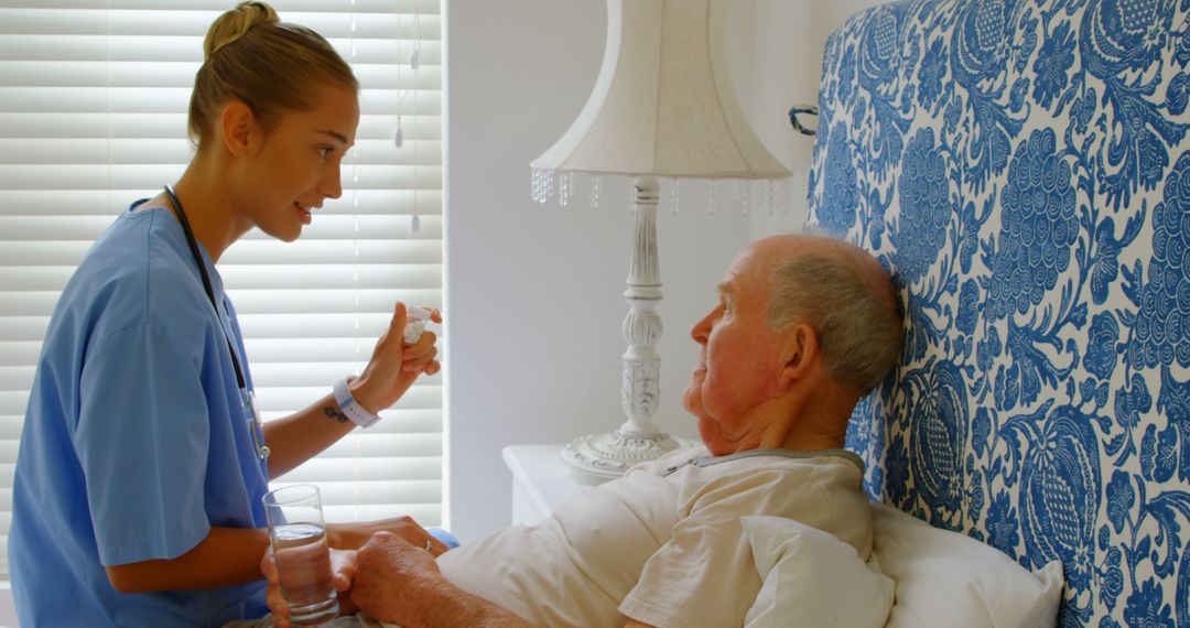 Nurse Assisting Elderly Patient at Home with Medication - Free Images, Stock Photos and Pictures on Pikwizard.com