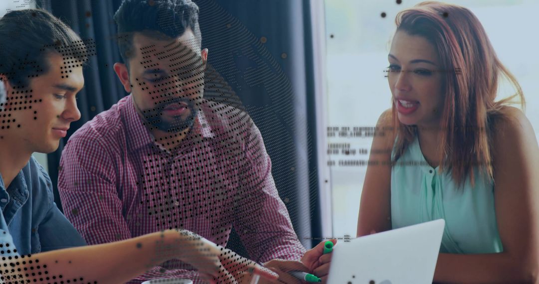 Team of Developers Collaborating on Laptop Presentation in Office
