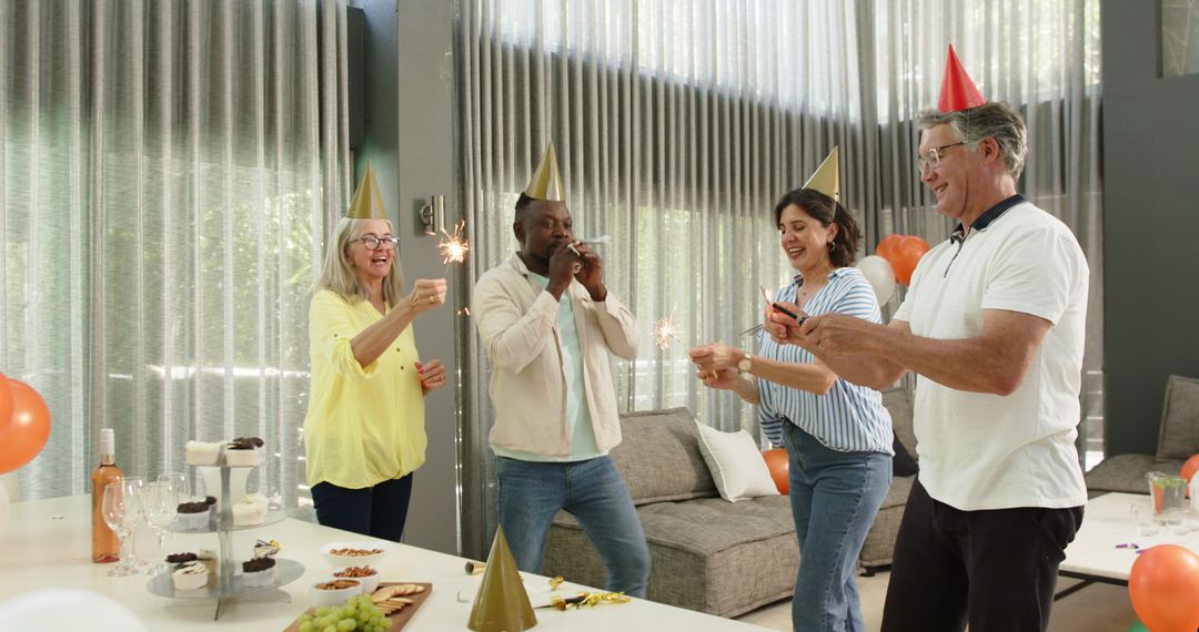 Colleagues Celebrating with Party Hats and Sparklers in Office Lounge