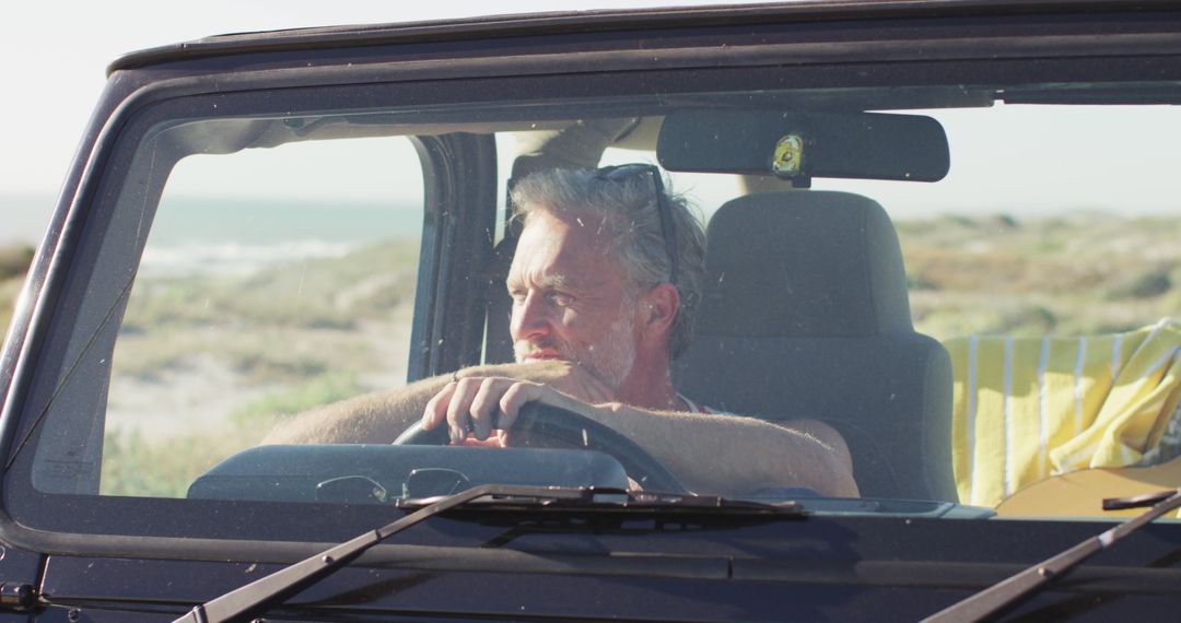 Middle-aged Man Driving Jeep Along Beach - Free Images, Stock Photos and Pictures on Pikwizard.com