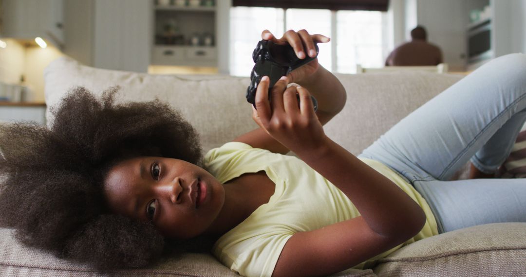 Young Girl Enjoying Video Game on Couch - Free Images, Stock Photos and Pictures on Pikwizard.com