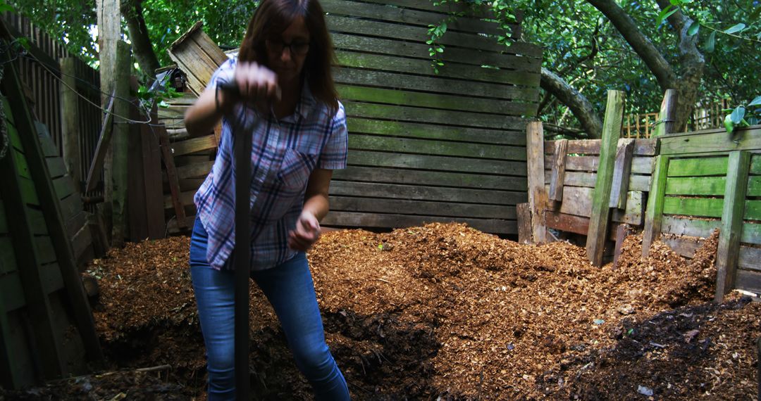 Woman Turning Compost in Backyard on Overcast Day - Free Images, Stock Photos and Pictures on Pikwizard.com