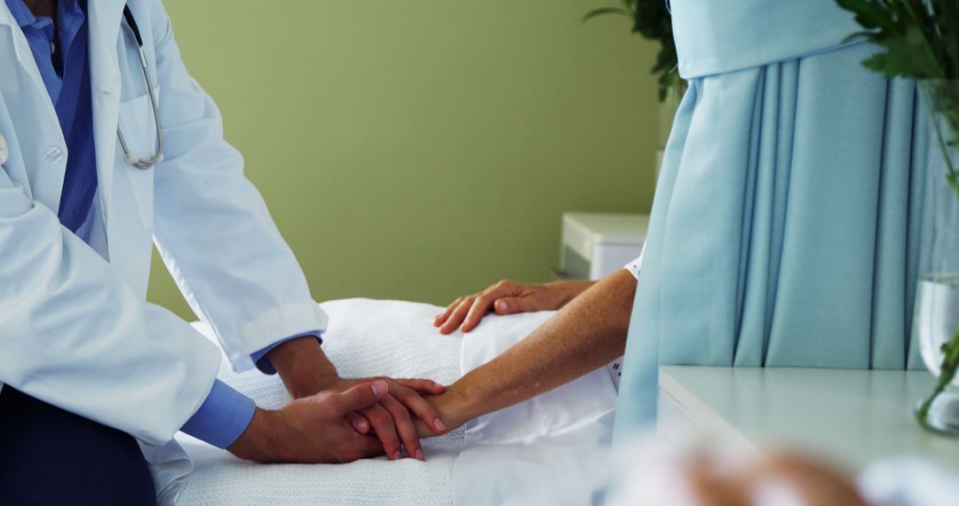 Doctor Holding Elderly Patient's Hands in Comforting Gesture at Hospital - Free Images, Stock Photos and Pictures on Pikwizard.com