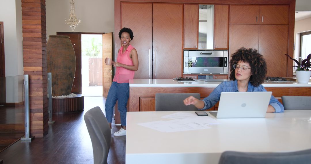 Female Couple Collaborating on Work from Home Documentation