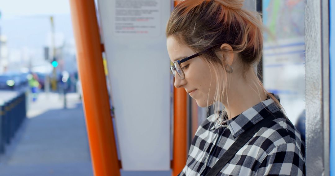 Young Woman Wearing Glasses Waiting at Bus Stop - Free Images, Stock Photos and Pictures on Pikwizard.com