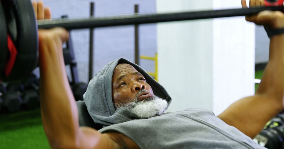 Elderly man lifting weights in gym during workout - Free Images, Stock Photos and Pictures on Pikwizard.com