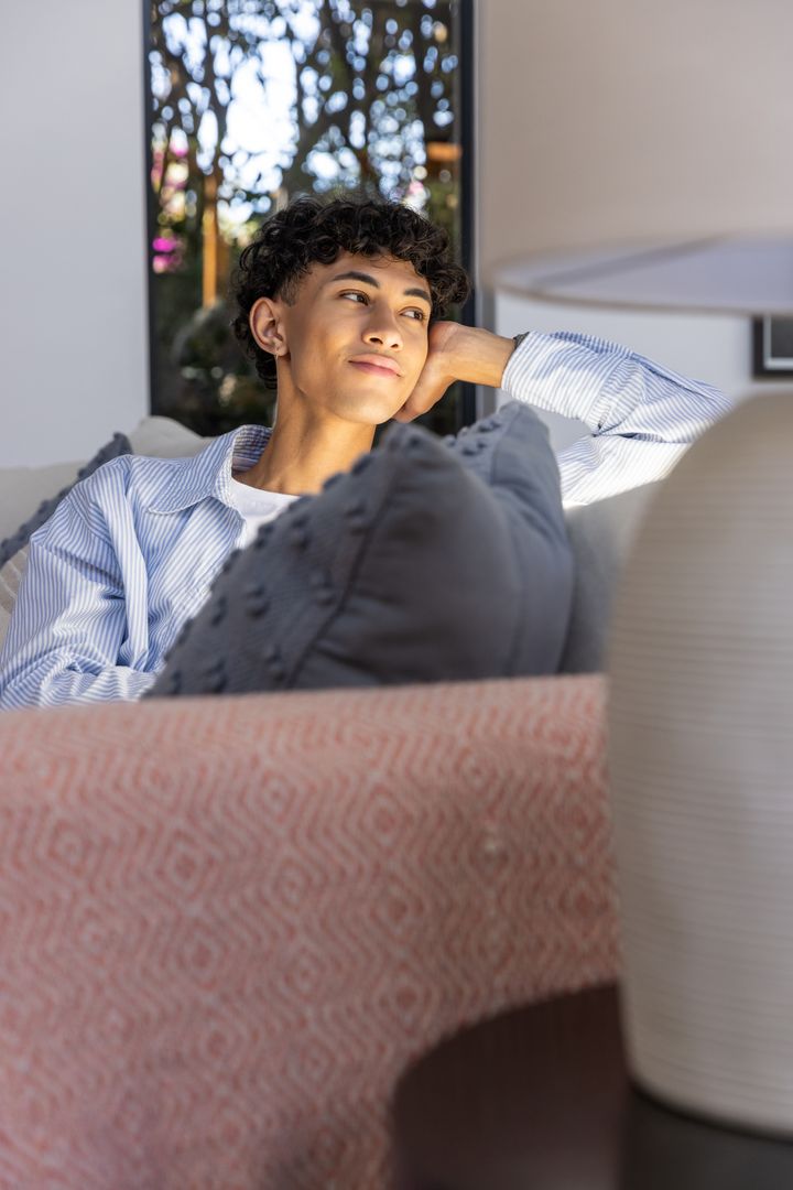 Man Relaxing on Modern Sofa in Cozy Living Room