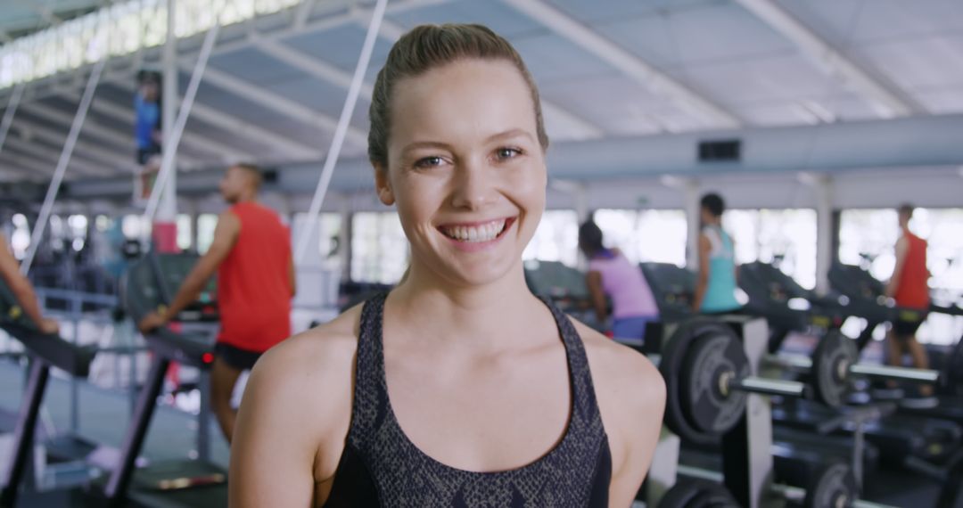 Smiling Young Woman in Gym - Free Images, Stock Photos and Pictures on Pikwizard.com