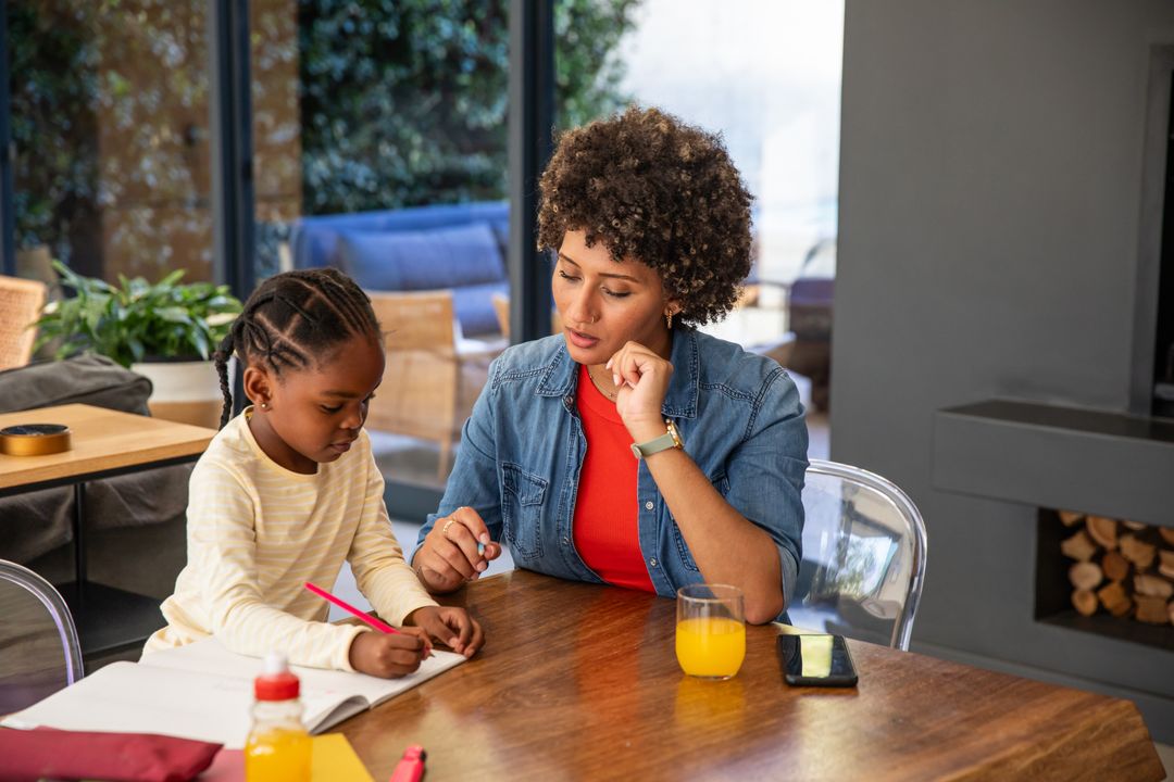 Mother and Daughter Engaged in Learning at Home