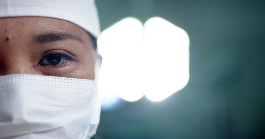 Close-Up of Focused Healthcare Worker Wearing Surgical Mask and Cap - Free Images, Stock Photos and Pictures on Pikwizard.com