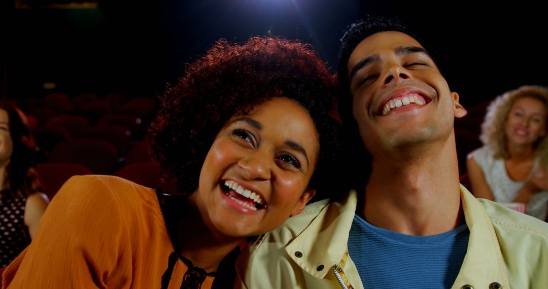 Young Audience Enjoying Movie in Theater with Joyful Atmosphere