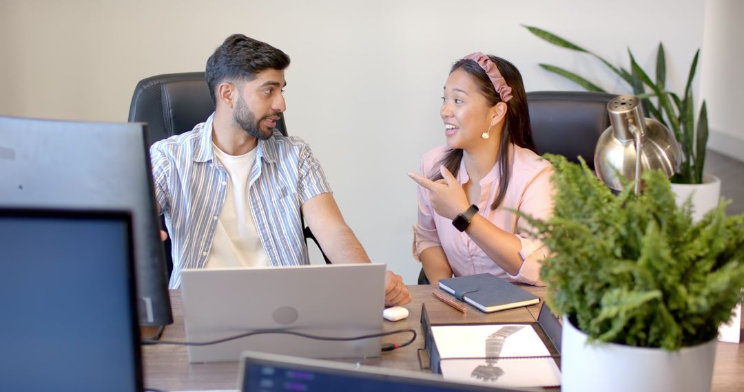 Colleagues Discussing Project in Modern Office Workspace