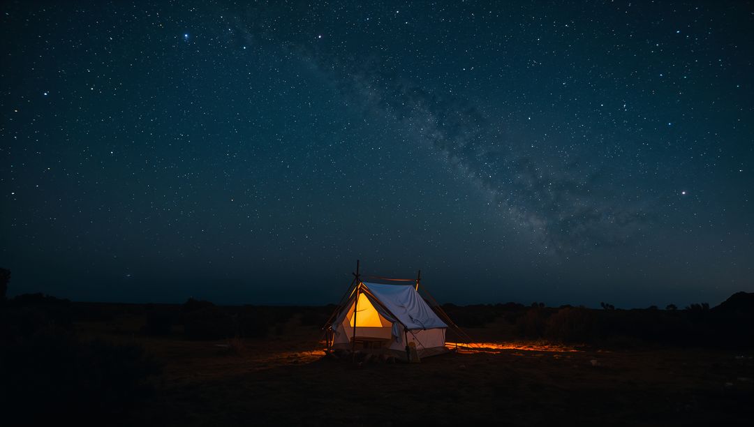 Glowing Canvas Tent Spilling Warm Amber Light Under Milky Way on Desert Plain at Night