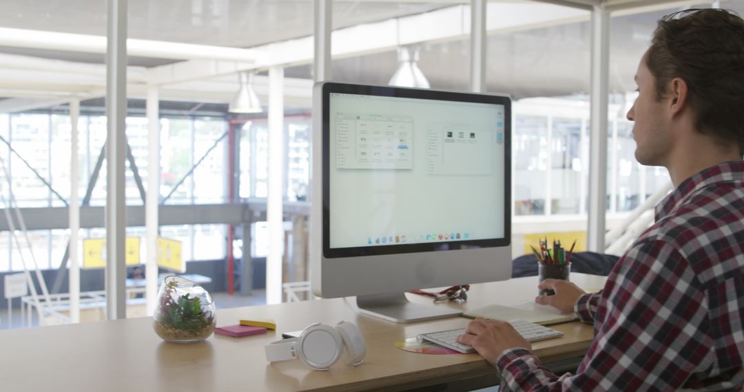 Concentrated Professional Studying Graphics at Work Desk
