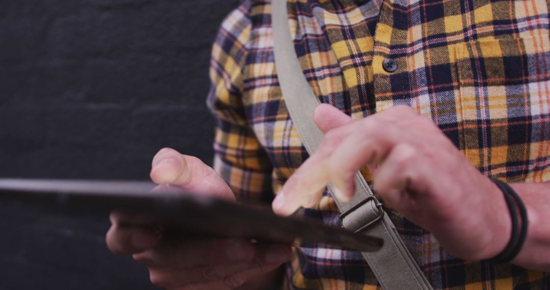 Person Using Digital Tablet and Wearing Yellow Plaid Shirt - Free Images, Stock Photos and Pictures on Pikwizard.com