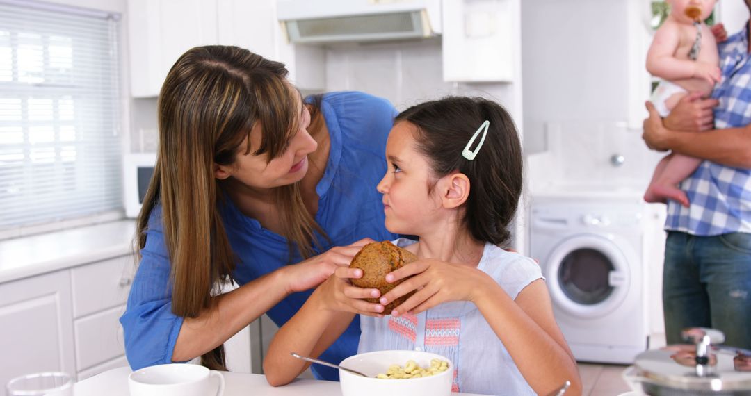 Mother and Daughter Sharing Breakfast in Kitchen - Free Images, Stock Photos and Pictures on Pikwizard.com