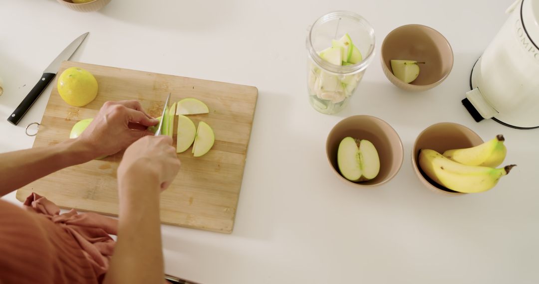 Top-view slicing fresh green apple for healthy recipe