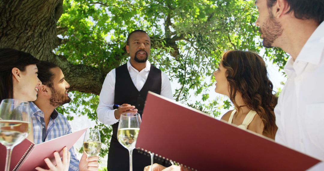 Waiter Taking Order from Diverse Couples in Outdoor Restaurant - Free Images, Stock Photos and Pictures on Pikwizard.com