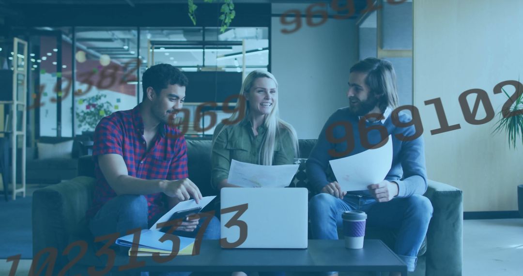 Team Collaborates in Modern Office Lounge Discussing Documents