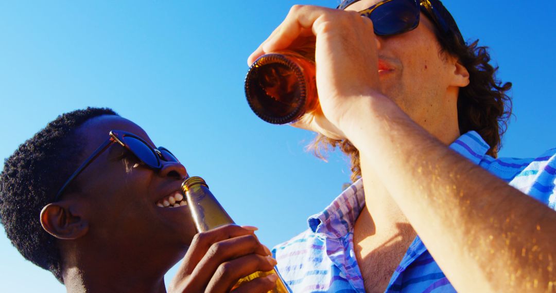 Friends Enjoying Refreshing Drinks Under Clear Blue Sky - Free Images, Stock Photos and Pictures on Pikwizard.com