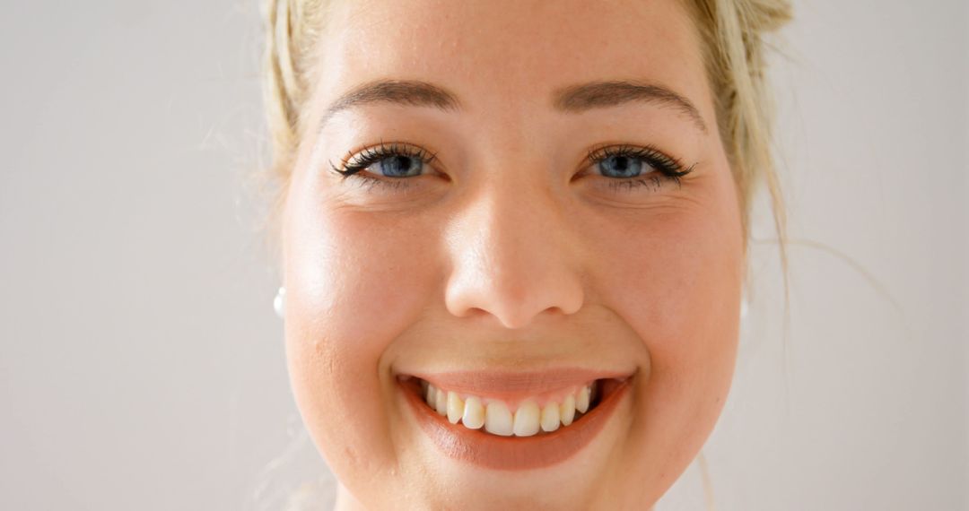 Close-Up of Smiling Young Woman with Blonde Hair - Free Images, Stock Photos and Pictures on Pikwizard.com