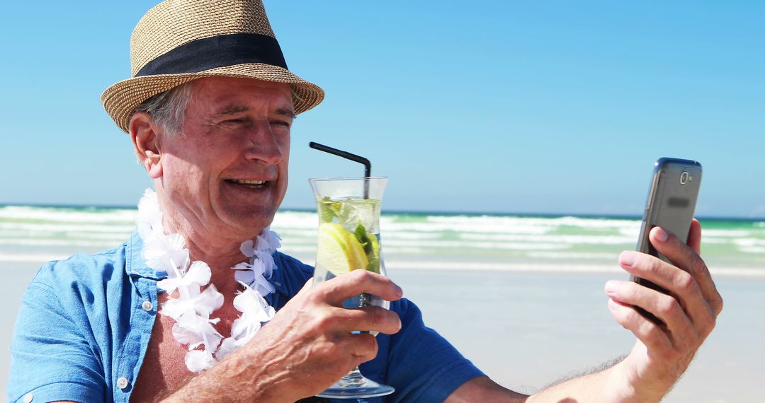 Senior man taking selfie on beach enjoying vacation - Free Images, Stock Photos and Pictures on Pikwizard.com