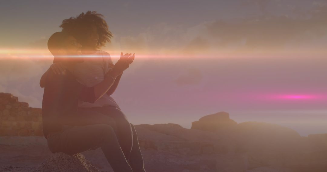 Couple Embracing on Rocks with Luminous Light Trails