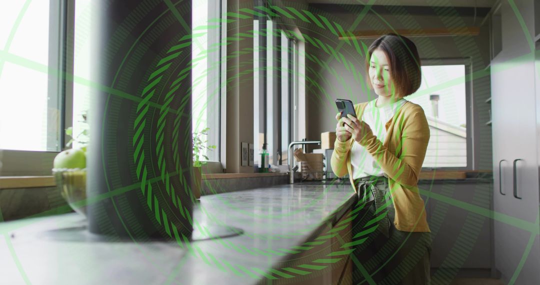 Young woman checking smartphone in minimalist kitchen with marble counter and kettle
