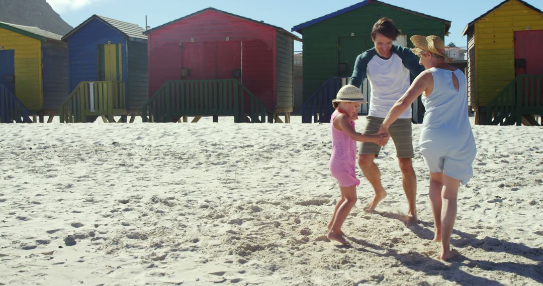 Family Enjoying Day at Colorful Beach Huts - Free Images, Stock Photos and Pictures on Pikwizard.com