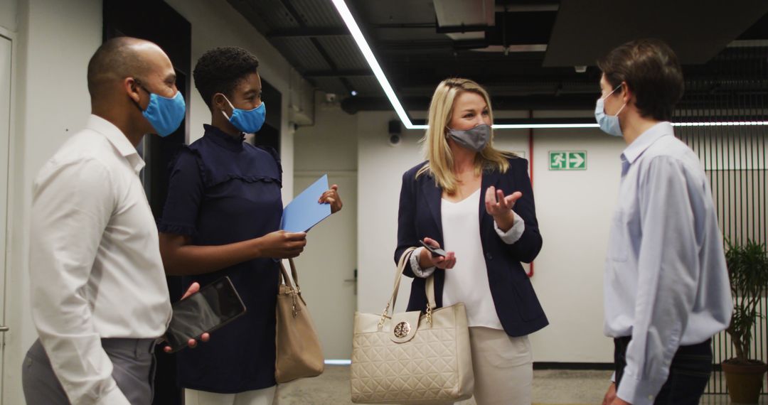 Professional Team Collaborating in Office While Wearing Masks
