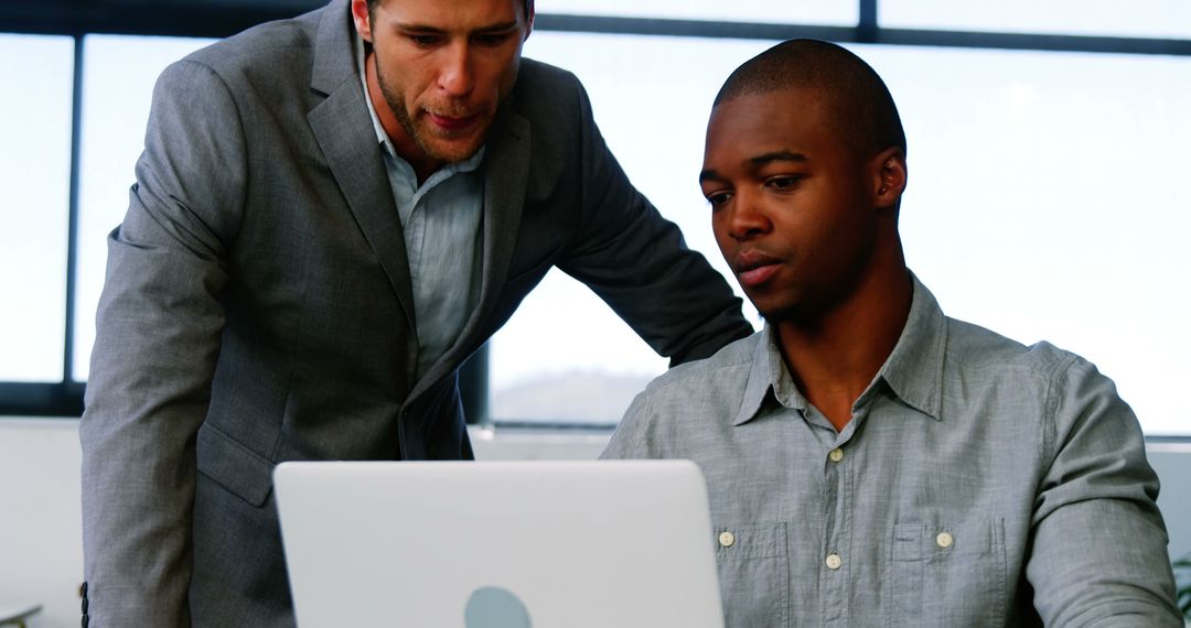 Two Businessmen Working Together on Laptop in Office - Free Images, Stock Photos and Pictures on Pikwizard.com