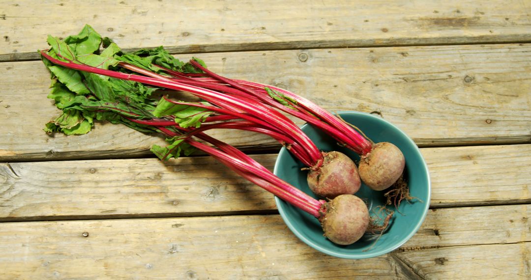 Fresh Organic Beetroots in Blue Bowl on Wooden Surface - Free Images, Stock Photos and Pictures on Pikwizard.com