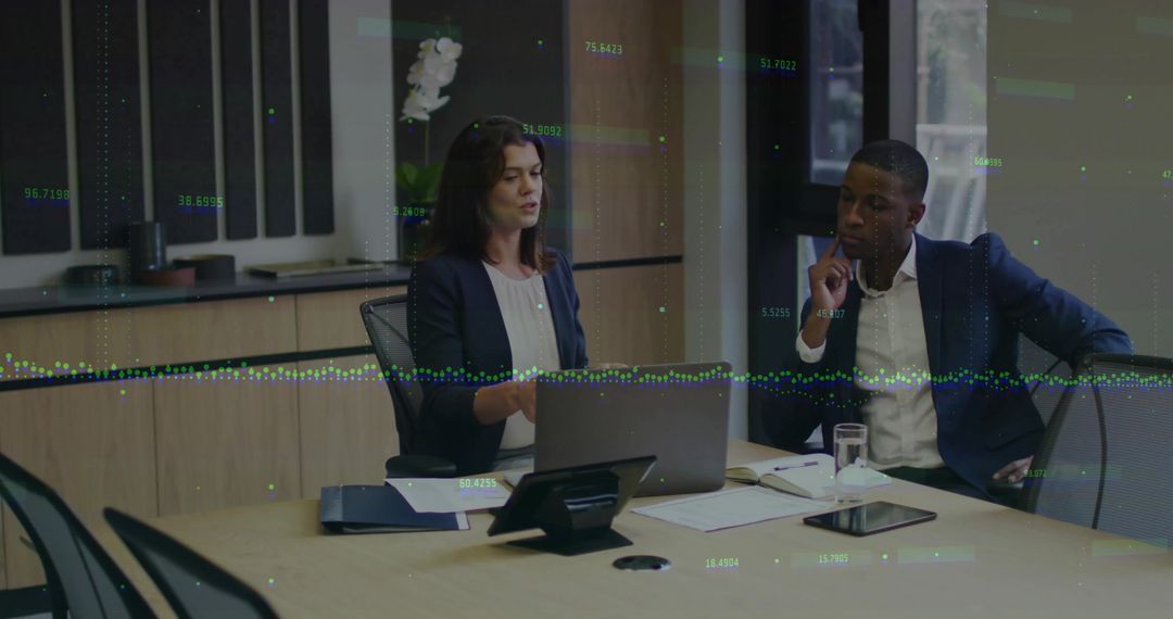 Business Duo Analyzing Data with Technology Overlays in Modern Office