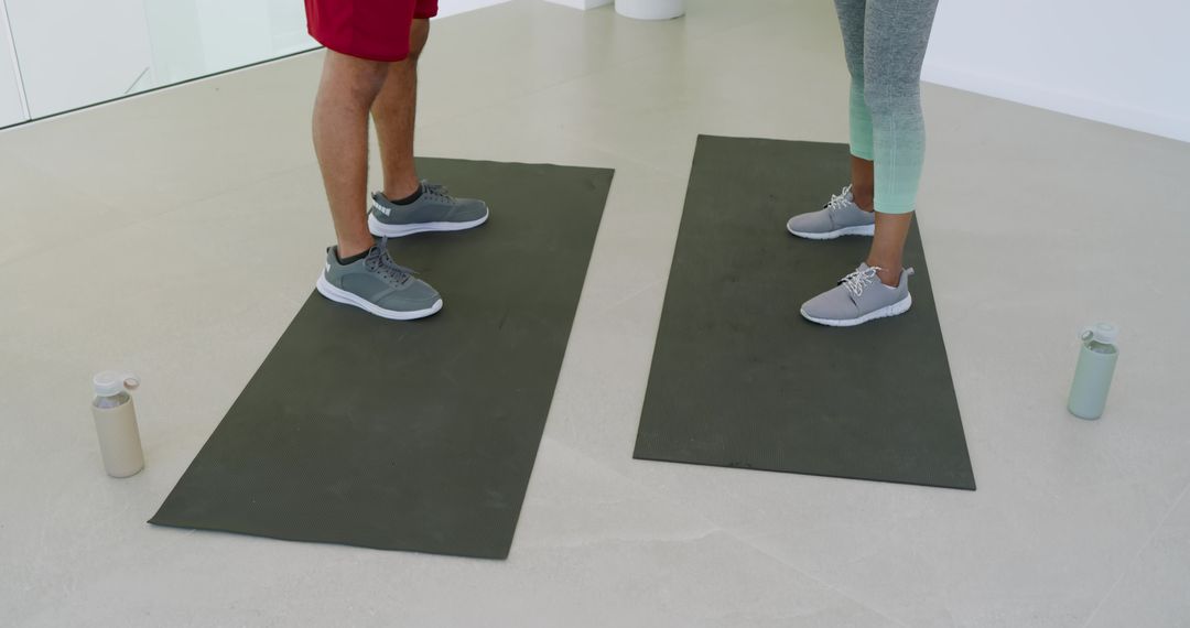 Workout Partners on Mats in Bright Fitness Studio