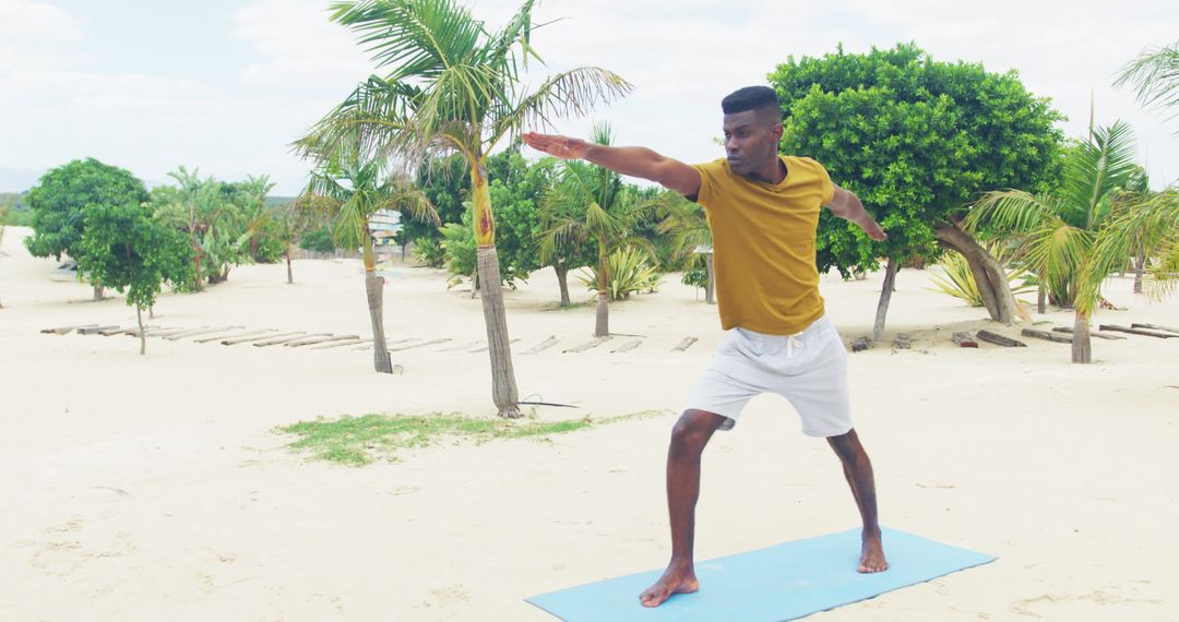 Young Man Doing Yoga on Tropical Beach - Free Images, Stock Photos and Pictures on Pikwizard.com