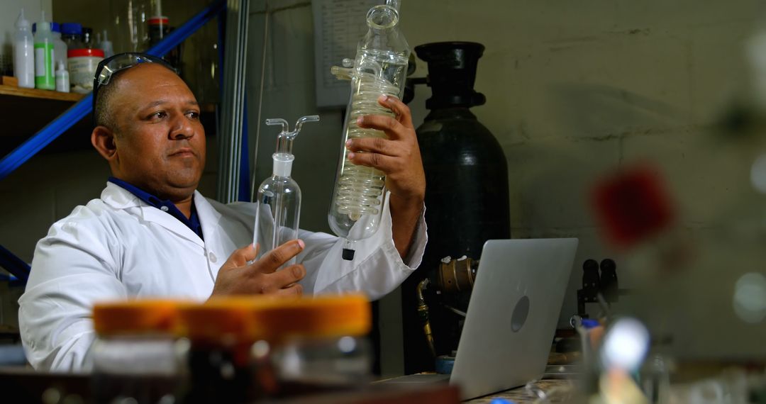 Scientist Examining Laboratory Equipment in Working Environment - Free Images, Stock Photos and Pictures on Pikwizard.com