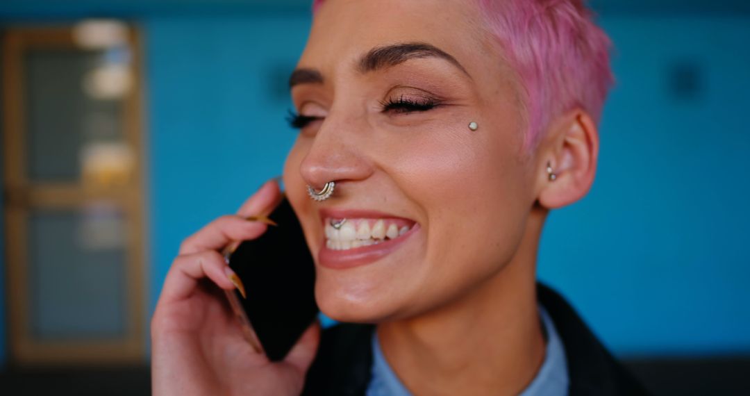 Close-Up of Happy Woman with Pink Hair and Nose Ring on Phone Call - Free Images, Stock Photos and Pictures on Pikwizard.com